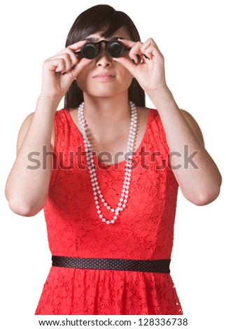 Serious woman in red looking through jewelers glasses