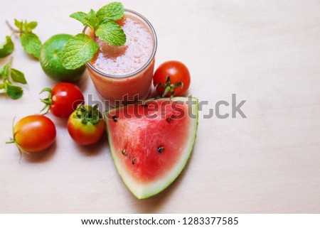 Glass  of Water melon tomato and lemon  juice on wooden table , healthy drink  made from  fresh food  image  use  for background or wallpaper , selective focus. 