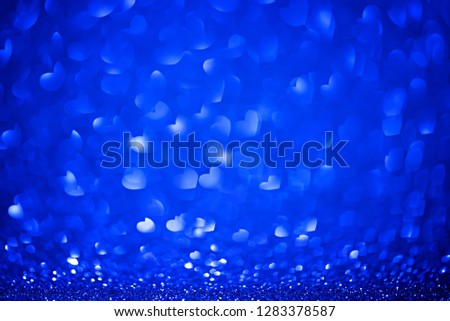 Blue shiny glitter holiday beautiful background with bokeh shape hearts. Valentine day concept bokeh texture. Studio shot. 