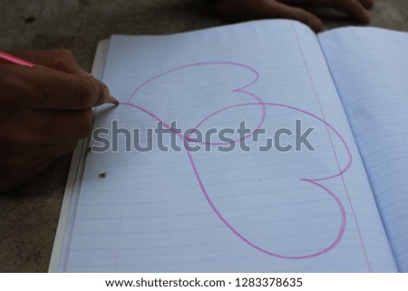 Children draw heart shape on paper