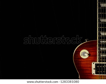 Red sunburst guitar isolated on black background