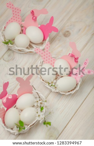 Happy easter. Decor of Easter eggs in small white baskets. Selective focus