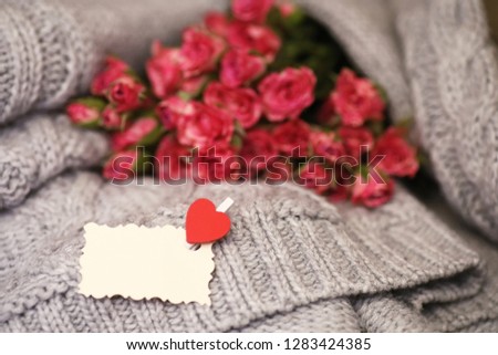 Bouquet of red roses on a textile sweater