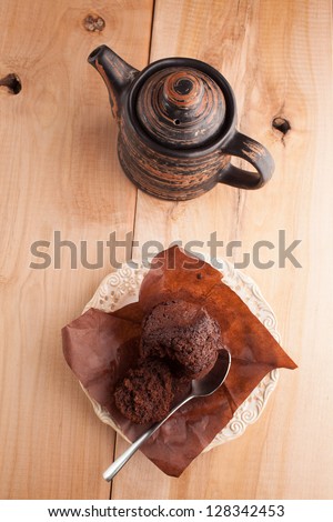 cake with green tea and tea pot on wooden table
