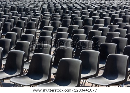 Rows of an empty black plastic seats