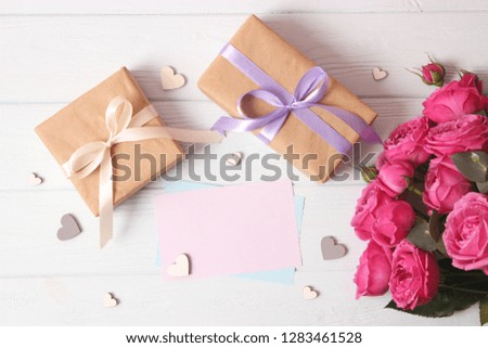 gift, flowers and hearts on a colored background. Background to Valentine's Day or Mother's Day. Holiday, give. International Women's Day.
