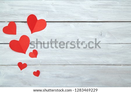 Red paper shape hearts isolated on white wood background, decorations for Valentine's Day, Empty space for design
