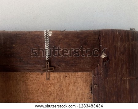 Close up view of Jesus christ cross christian praying for life symbol on old vintage grunge wood door concept picture loving God with selective focus