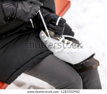 Closeup shot of woman tying the skates