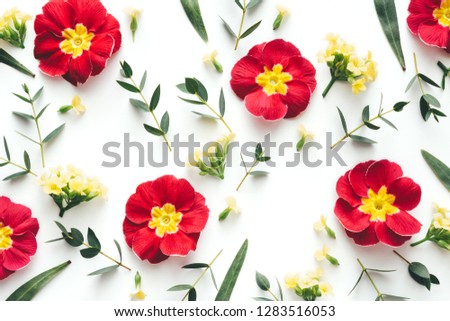 Floral patternmade of red and yellow flowers on white background. Flat lay. View from above.