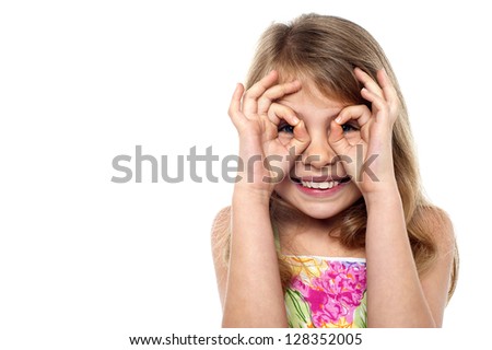 Fun loving young girl in playful mood. Isolated over white background.