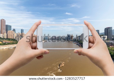 Businessman hand holding empty screen smart phone with city background.
