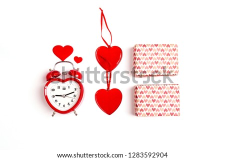 Valentine's day  composition with alarm clock, gift boxes and hearts on white background. Flat lay, top view. Time for love and greetings.