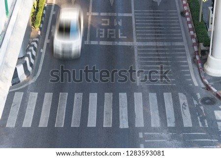 Crosswalk and car, Busy city street and car in motion blur on crosswalk