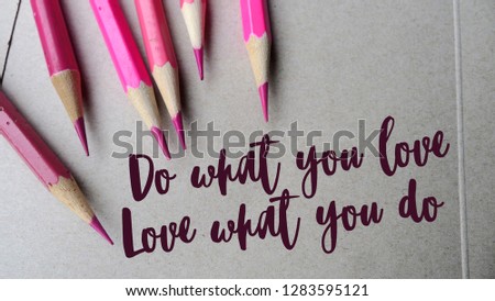 Do what you love, love what you do - Quote Typographical Background. Modern Inspirational message written on a brown craft paper background with pink color pencils.