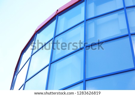 Modern office building with tinted windows against blue sky