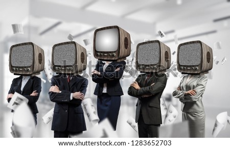 Business people in suits with old TV instead of their heads keeping arms crossed while standing in a row among flying paper documents inside office building.
