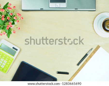 Office table with Laptop,keyboard,tablet,Smartphone,Pen,Calculator,Hot coffee and Flowers, copy space,flat lay,Top view