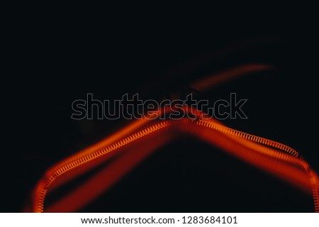 electric tungsten lamp. Glow filament bulb closeup isolated on black background. macro photo of red-hot spiral. technology, abstraction, backgrounds, textures