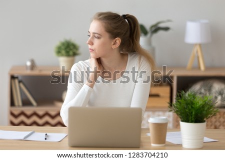 Thoughtful pensive female student looking away thinking of problem solution, serious young woman searching inspiration new ideas working on laptop lost in thought, creativity crisis, writers block Royalty-Free Stock Photo #1283704210