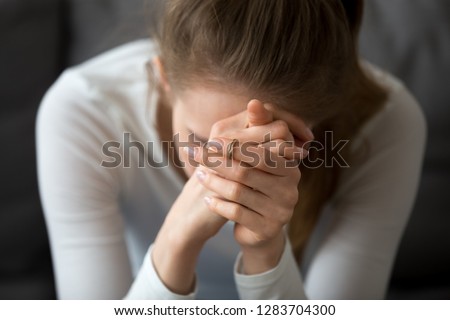 Sad depressed woman feeling bad down hopeless crying alone, upset teen female victim in trouble being heartbroken offended abused, having problem addiction, girl in despair concept, close up view Royalty-Free Stock Photo #1283704300