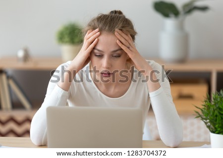 Stressed frustrated young woman student looking at laptop reading bad email internet news feeling sad tired of study work online, upset about problem, failed exam test results, difficult learning Royalty-Free Stock Photo #1283704372