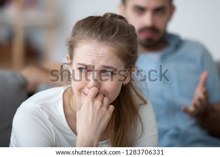 Stressed woman crying feeling depressed offended by controlling husband tyrant blaming wife of problems in unhappy marriage, sad girl in tears worried about family fight and relationships problems Royalty-Free Stock Photo #1283706331