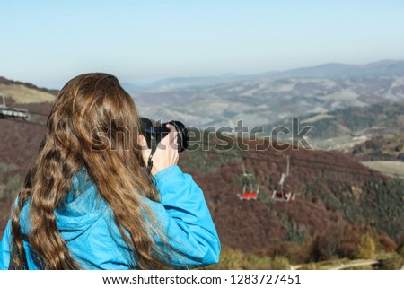Professional nature photographer taking photo of mountain landscape