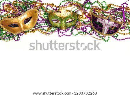 Festive Carnival background with masks, beads and copy space. Carnivale mask on a white background. 