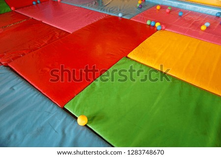  Old  colorful leather pad in playground with plastic ball                              