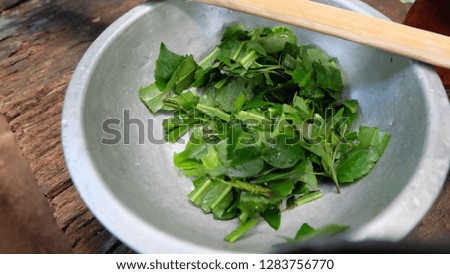 Bowl of herb leaves like leech lime and basil vegetable