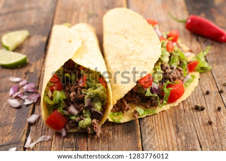 tacos, fajita on wood background