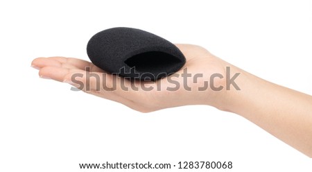 hand holding sponge cap for music microphone isolated on white background