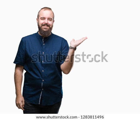Young caucasian hipster man over isolated background smiling cheerful presenting and pointing with palm of hand looking at the camera.