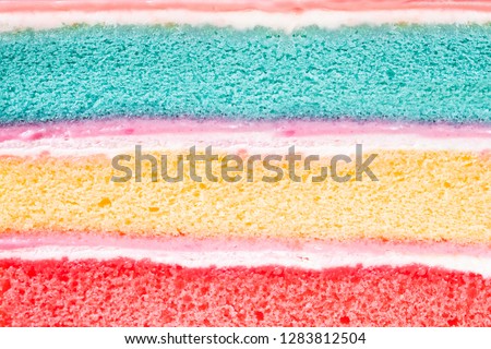 layer rainbow cake and 
whip cream background,dessert homemade colorful