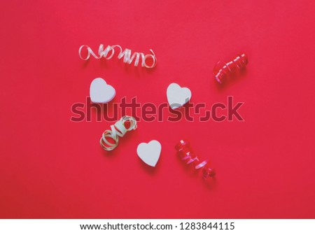 Love or Valentines Day concept. Confetti Hearts on red background. Festive backdrop for package and projects. Flat lay, close up.
