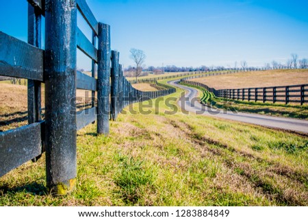 horse pasture farm fence along road Royalty-Free Stock Photo #1283884849