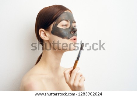 clay mask woman with brush care spa procedure