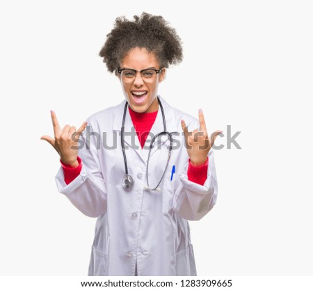 Young afro american doctor woman over isolated background shouting with crazy expression doing rock symbol with hands up. Music star. Heavy concept.