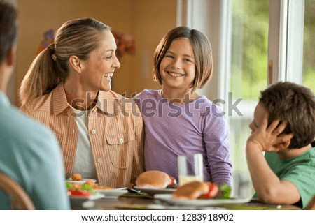 Happy family having fun eating at a dining table.