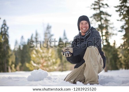 Young man preparing to throw a snowball
