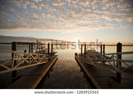 A wharf with a cloudscape and beautiful sunset