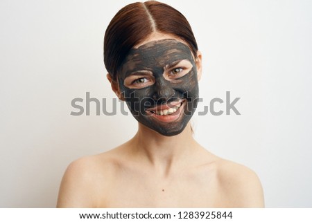 young woman smiling in clay mask portrait