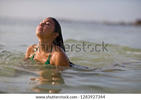 Young adult woman swimming in the sea.