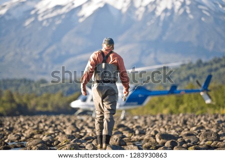 Man walking towards a helicopter