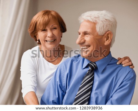 Portrait of a senior businessman and his wife at home.