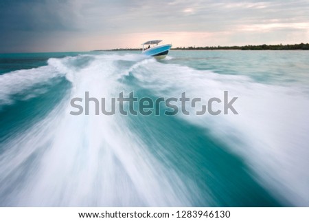 Waves breaking in the wake of a jet boat on the ocean.