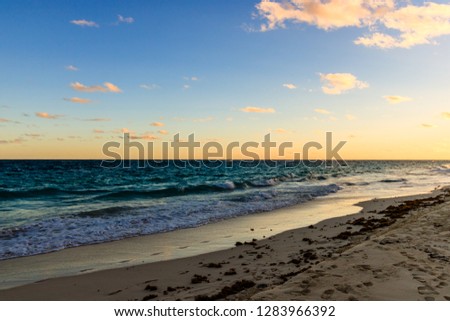Paradise travel destination beach in Hamilton, Bermuda. Elbow Beach with golden sand and a beautiful sunset.