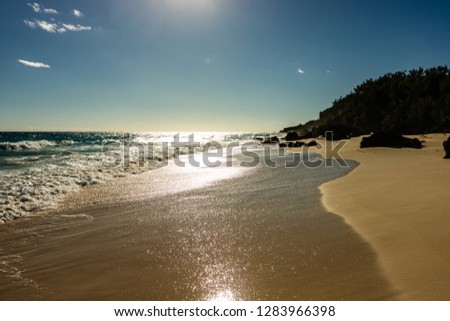 Paradise travel destination beach in Hamilton, Bermuda. Elbow Beach with golden sand and a beautiful sunset.