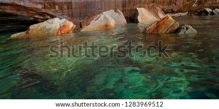 Usa, Michigan. Mineral seep wall and fallen boulders on shoreline of Lake Superior, Pictured Rocks National Lakeshore